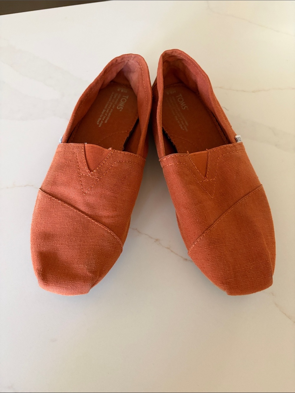 TOMS Women's Slip-On Moccasins in Rust Orange Canvas